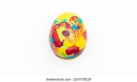 Easter composition with a colored chicken egg on a white background. Concept of Easter parties.