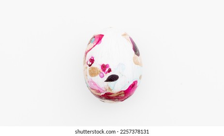 Easter composition with a colored chicken egg on a white background. Concept of Easter parties.