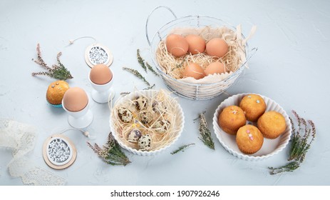 Easter composition with eggs and colorful sweets on light gray background. Seasonal holiday concept. 