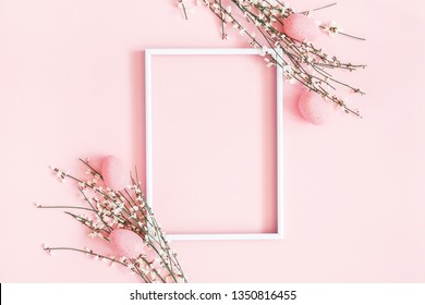 Easter composition. Easter eggs, photo frame, white flowers on pastel pink background. Flat lay, top view, copy space. - Shutterstock ID 1350816455