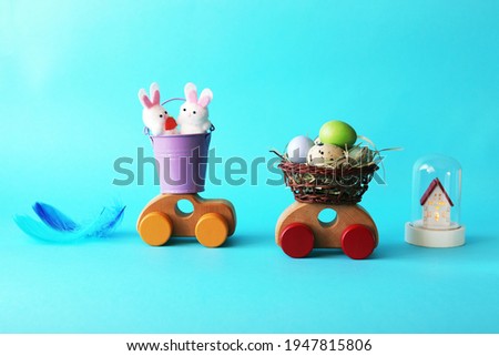 Easter composition of eggs and toys on a bright background, home holiday concept, congratulations, postcard