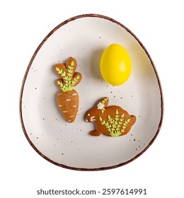 Easter composition isolated on white. Dyed egg and Easter cookies on egg-shaped plate. Top view.