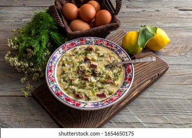 The easter composition. National Greek soup "Magiritsa" in a bowl, which is prepared once a year on Easter, on a wooden table close-up