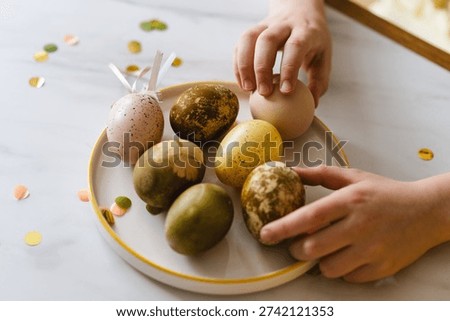 Easter composition with natural dyed eggs in pastel tones on a plate. Eco friendly Easter eggs colored with natural ingredients. Spring holiday concept, lifestyle and modern rustic decoration.