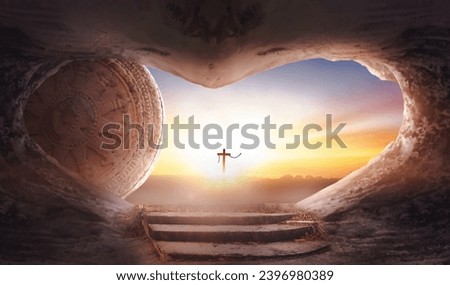 Easter concept: Empty tomb stone with cross on  sunrise background