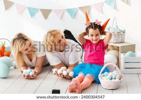 Easter concept. Happy llittle girl and grandmother with Easter eggs