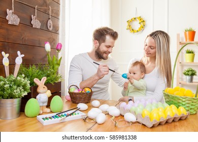 Easter Concept. Happy And Loving Mother And Father Preparing Home Decoration With Their Child For Easter Holidays