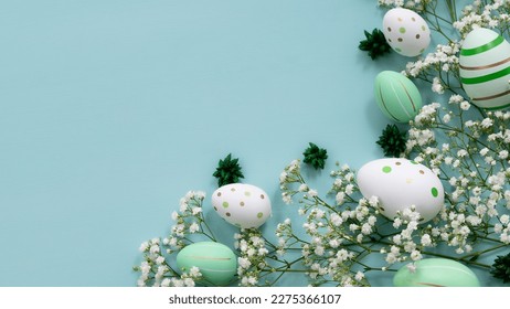 Easter concept. Top view photo of colorful easter eggs with white Gypsophila  on isolated pastel green background with copy space - Shutterstock ID 2275366107