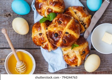 Easter cross buns, decorated with eggs. Light background, copy space, Easter food concept.