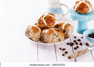 Easter cross-buns on white wooden background with copy space. Selective focus, shallow depth of field