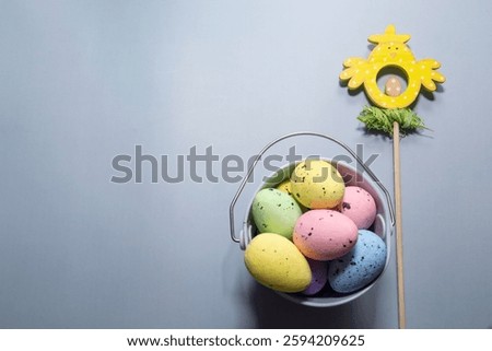 Easter decor on a light background, colorful eggs and buckets
