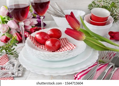 Easter Decoration Table Red Tulips With Red Easter Eggs And Red Wine On Wooden Background