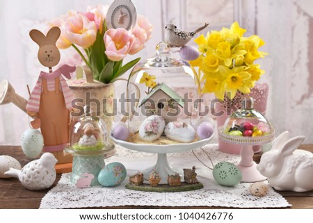 Easter decoration under glass dome,flowers and eggs on the table 
