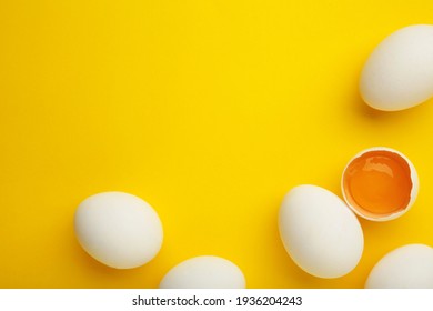 Easter decoration white eggs on yellow background. Top view
