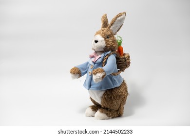 Easter Decorations Hare Rabbit of straw. Easter toy rabbit made of straw with a basket isolated on a white background - Powered by Shutterstock