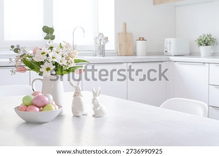 Easter decorations on table with copy space and modern kitchen counter interior