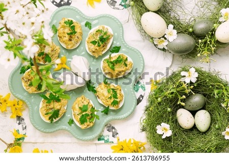 Easter deviled eggs with fried champignons on Easter background..top veiw.selective focus