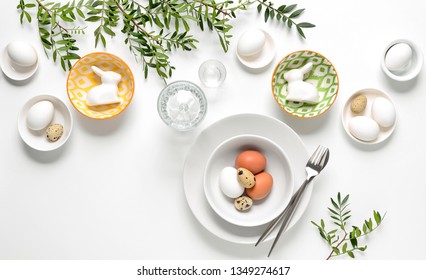 Easter dinner table setting, home holiday decor concept, view from above, blank space for a text