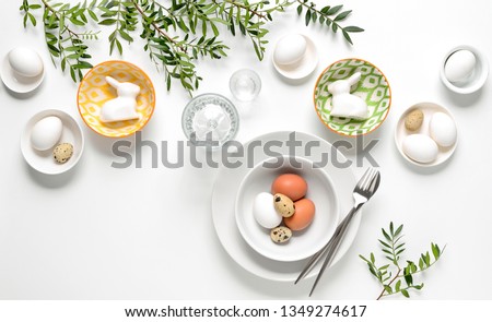 Easter dinner table setting, home holiday decor concept, view from above, blank space for a text