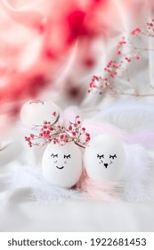 Easter DIY do it yourself. Minimal easter concept. Easter eggs with painted smiley faces and bird feather on pastel background. Married. Valentines day Wedding couple eggs. Easter holiday concept 
