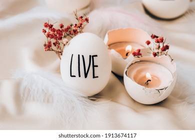 Easter DIY. Do it yourself. Trendy Easter eggs Composition. Easter message, Words drawn with pen. High Angle View Of Shells On Table. Live. Candle in egg shell. Candle light Pastel colors.