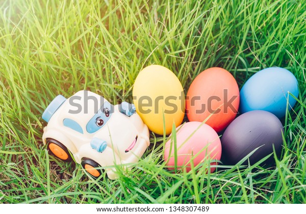 Easter egg and Car on grass background, happy\
easter day concept