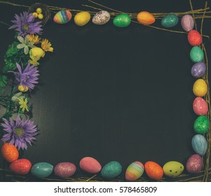 Easter Egg Framed Copy Space Square VIntage. Easter eggs and spring flowers arranged in a square with blank black copy space. Edited with vintage film effects.
