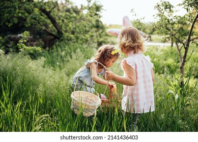 Easter egg hunt. Group Of Children Wearing Bunny Ears Running To Pick Up colorful Egg On Easter Egg Hunt In Garden. Easter tradition - Powered by Shutterstock