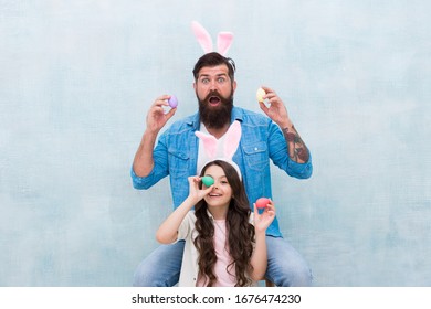 Easter Egg Hunt. Happy Family Wear Bunny Ears. Fun And Happiness. Father And Daughter Hold Easter Eggs. Spring Holiday Party. Small Kid Girl And Dad In Rabbit Costume. Painted Eggs.