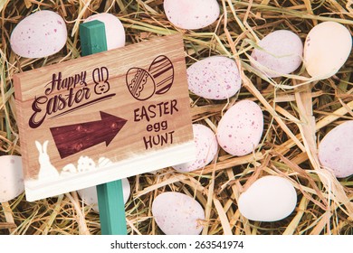 Easter Egg Hunt Sign Against Little Candy Easter Eggs On Straw