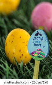 Easter Egg Hunt Sign Against Small Speckled Easter Eggs