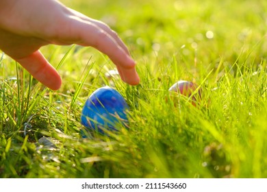 Easter Egg Hunt.Child Hand Collect Eggs In The Spring Garden. Collecting Easter Eggs.Easter Holiday Tradition.Spring Religious Holiday