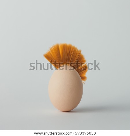 Easter egg with mohawk hair. Flat lay. Minimal concept.