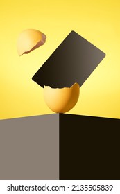 The Easter egg is on a black table.  A black card comes out of the Easter egg. Broken Easter egg.  Happy Easter.