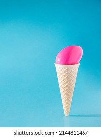 Easter Egg Pink In Ice Cream Cone. Ice Cream Standing Straight And Making Sunny Day Shadow. Abstract Holiday Spring Design