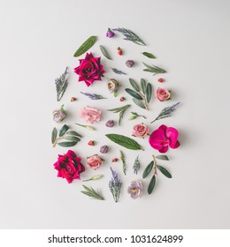 Easter Egg Shape Made Of Colorful Spring Flowers And Green Leaves.  Minimal Holiday Concept. Flat Lay Pattern.