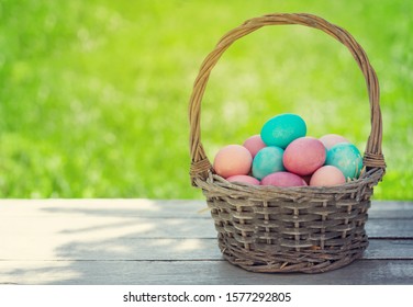 Easter eggs basket in a green grass garden. With copy space for your greetings