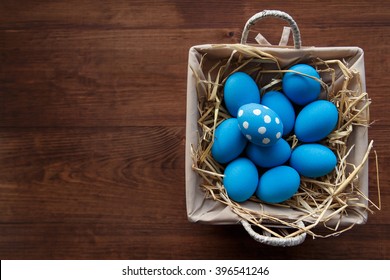 Easter eggs  in a basket on rustic wooden background, selective focus image, Happy Easter!