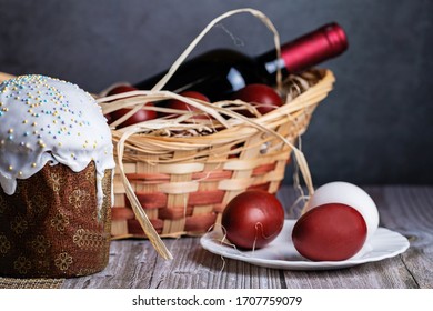 Easter Eggs In A Basket With Red Wine On A Wooden Table. Preparing For The Light Holiday Easter.