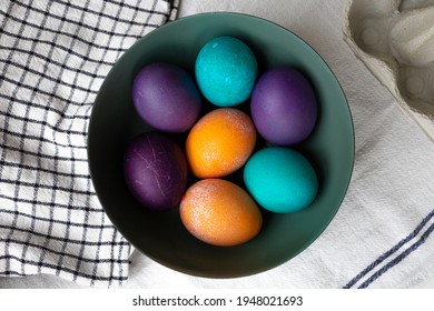 Easter Eggs  In Blue, Turquoise, Purple, And Orange In A Bowl.