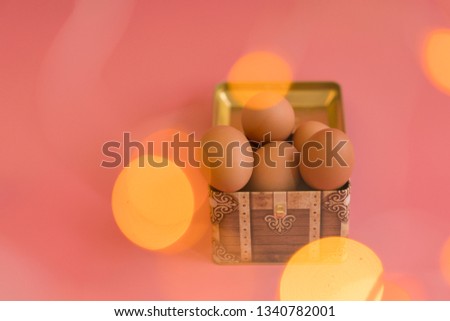 Easter eggs in a chest on a pink background. bokeh