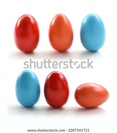 Easter Eggs closeup. Set of few colorful dyed eggs isolated on white background. Colored in red, orange and gentle blue, rubbed with olive oil for shine and brightness accordong to Greek tradition.