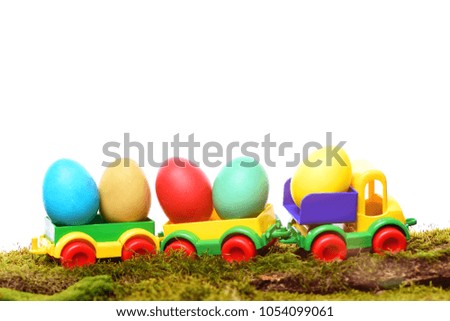 easter eggs easter colorful eggs painted in bright colors in plastic car toy isolated on white background with moss, spring holiday celebration, copy space