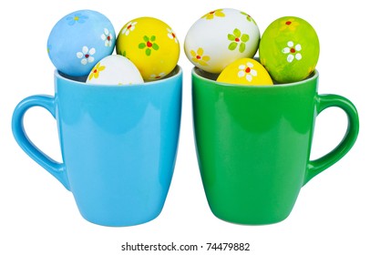 Easter eggs in cups on white background