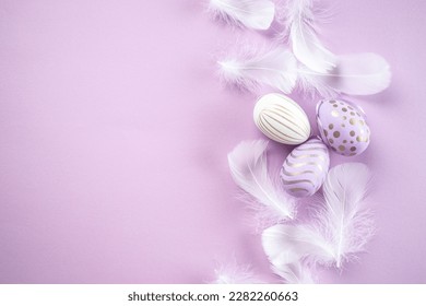 Easter eggs with feathers on purple background. Happy Easter holiday concept. - Powered by Shutterstock