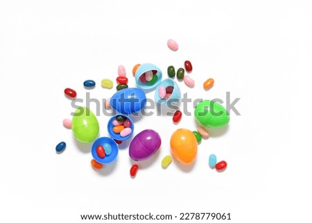 Easter eggs with jellybeans candy on white background