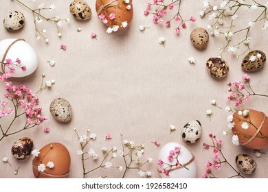 Easter eggs with natural flowers decor on linen background. Zero Waste Easter Concept. Frame for text in neutral colors