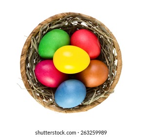 Easter Eggs In Nest Basket Isolated On White Background. Top View