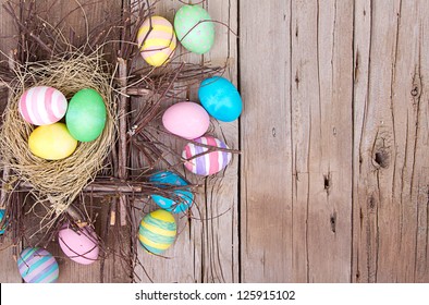 Easter eggs in nest on rustic wooden planks