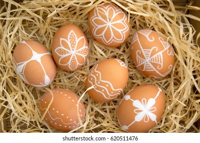 Easter eggs in nest on rustic wooden planks